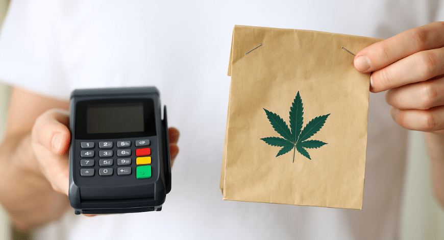 Person holding a card reader and a paper bag with a cannabis leaf, illustrating safe online purchasing of BC pot